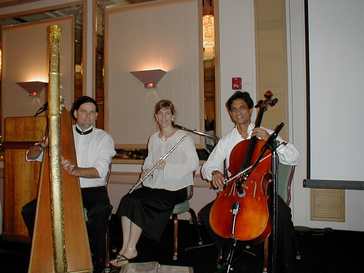 a string trio playing at the royal Hawaiian hotel
